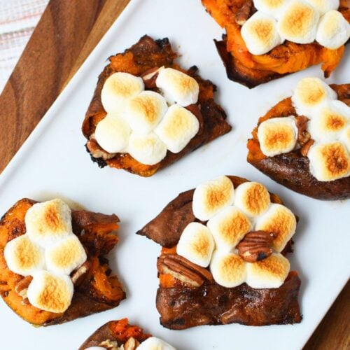 Thanksgiving smashed sweet potatoes with toasted marshmallows and pecans arranged on a serving platter