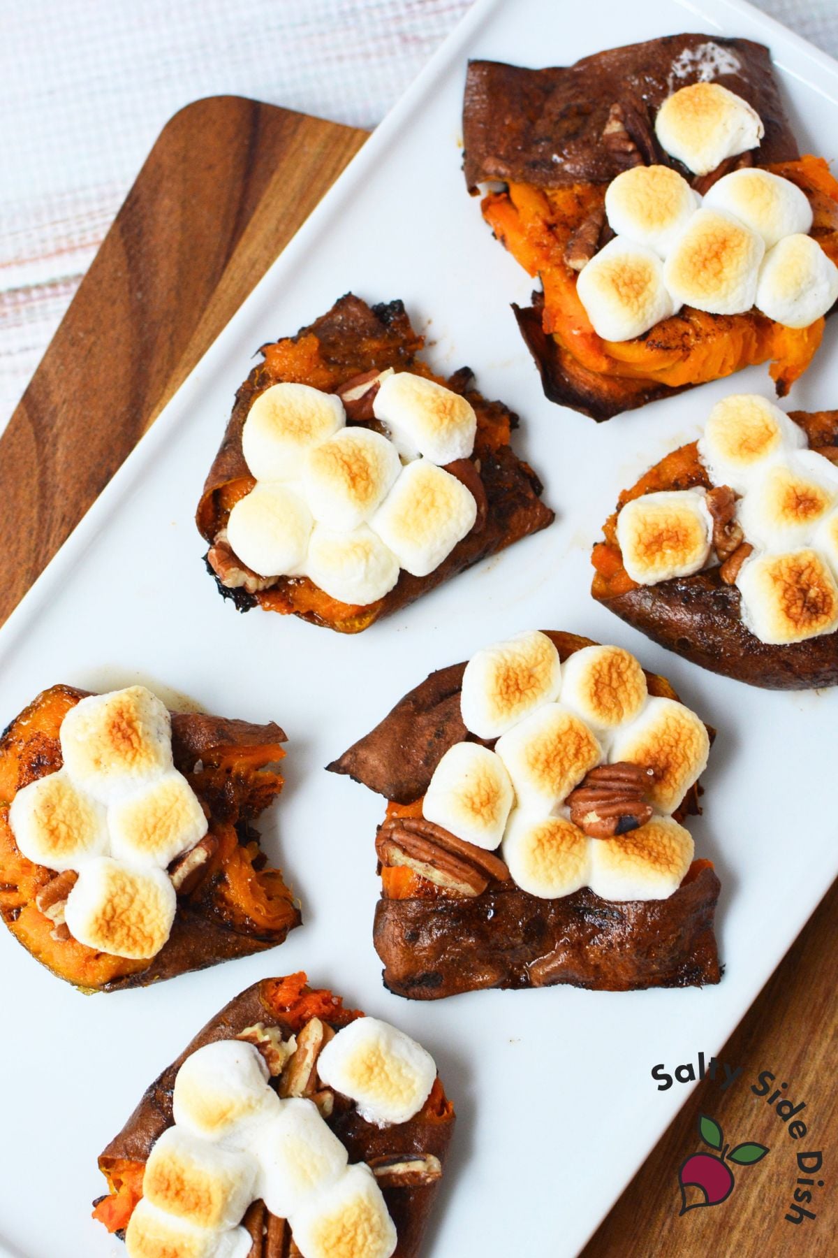Thanksgiving smashed sweet potatoes with toasted marshmallows and pecans arranged on a serving platter