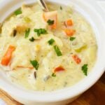Creamy chicken wild rice soup with tender chicken, carrots, celery, and wild rice in a white bowl