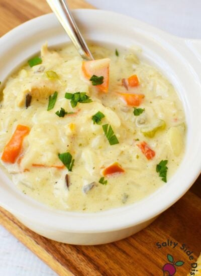 Creamy chicken wild rice soup with tender chicken, carrots, celery, and wild rice in a white bowl
