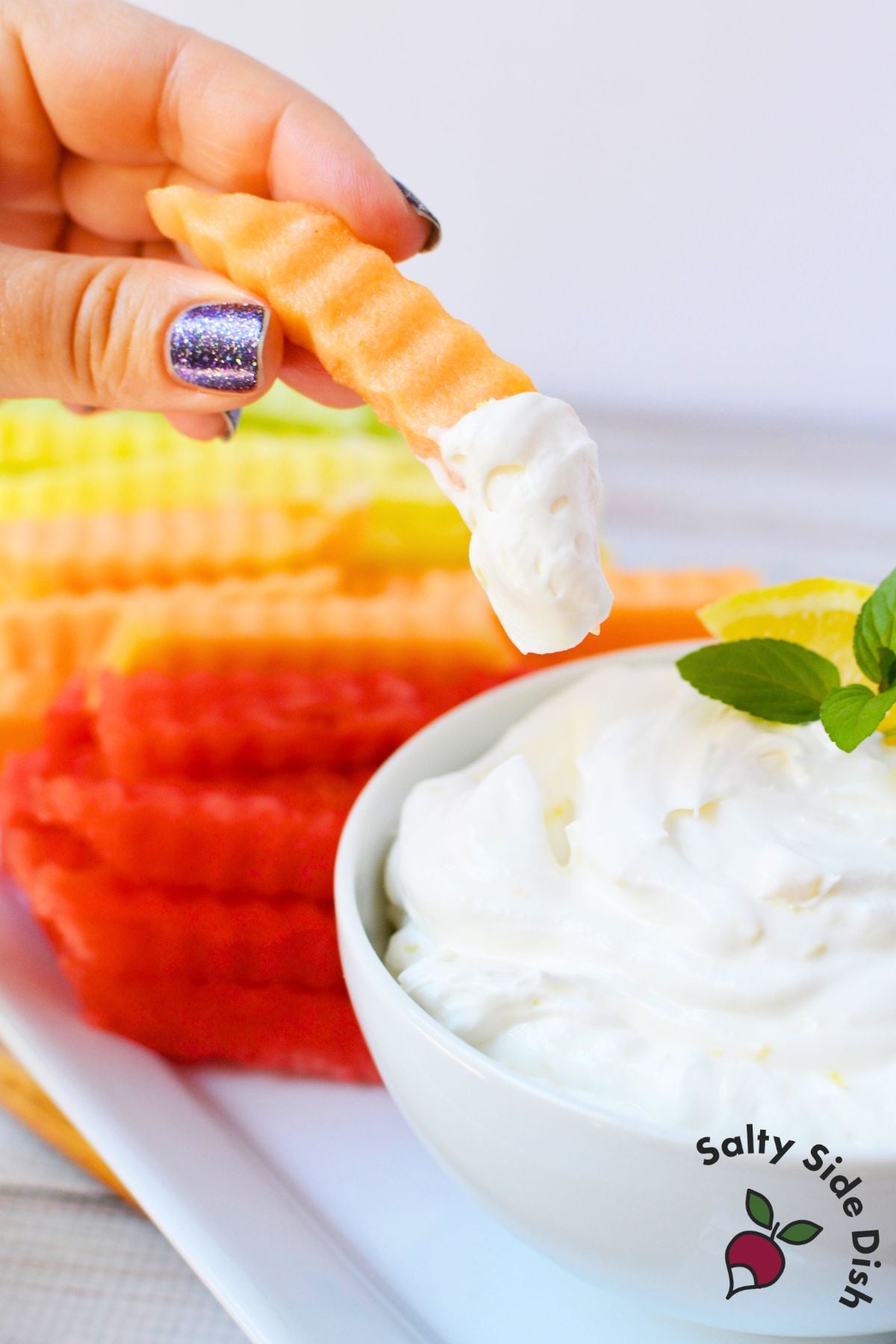 Crinkle-cut cantaloupe fruit fry dipped into fluffy lemon yogurt dip made with cool whip.