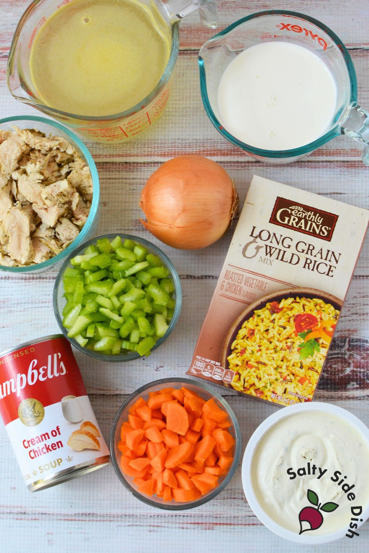 Ingredients for creamy chicken wild rice soup including cooked chicken, rice mix, vegetables, broth, and cream cheese
