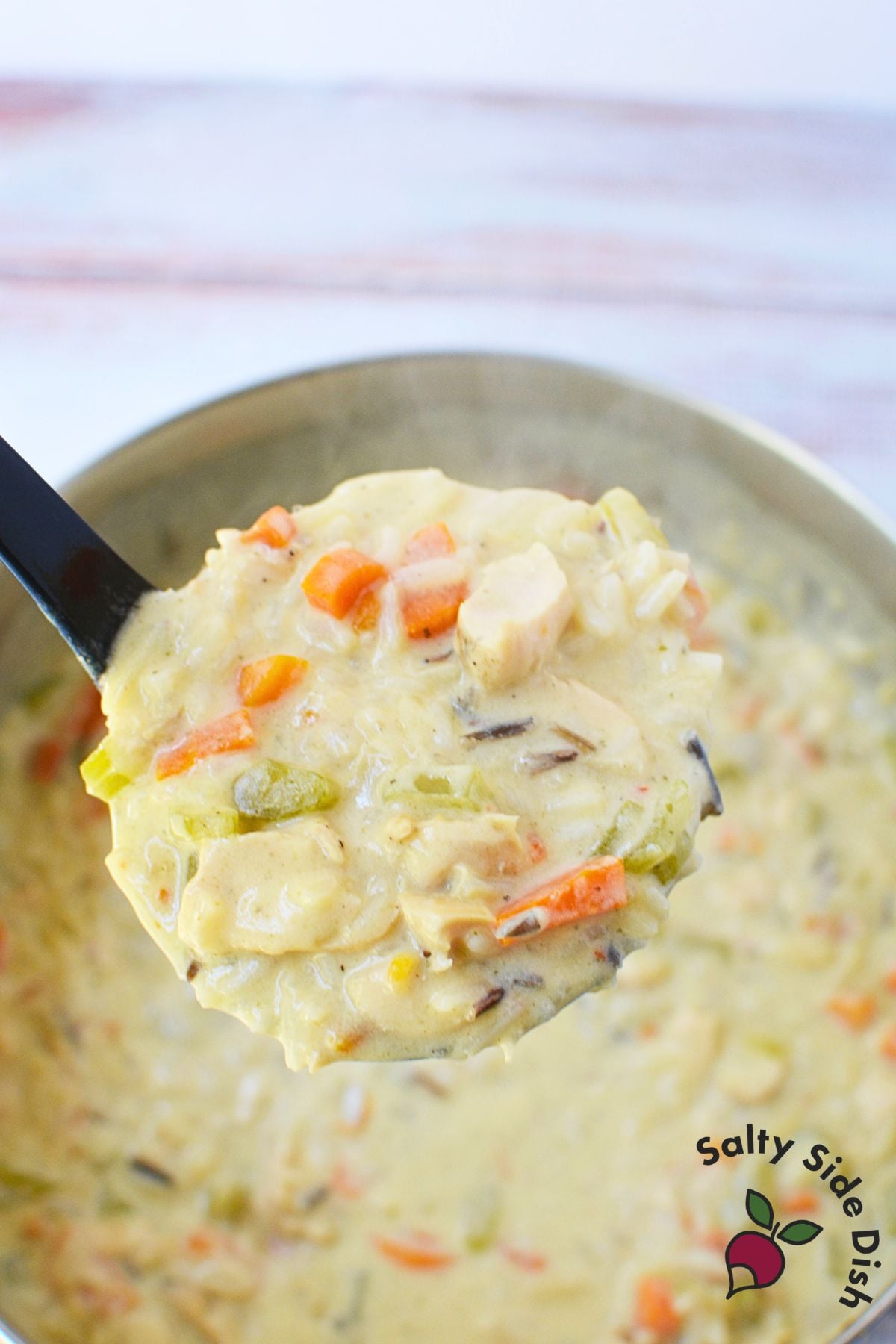 Homemade chicken and wild rice soup with a creamy broth, chicken, carrots, and celery