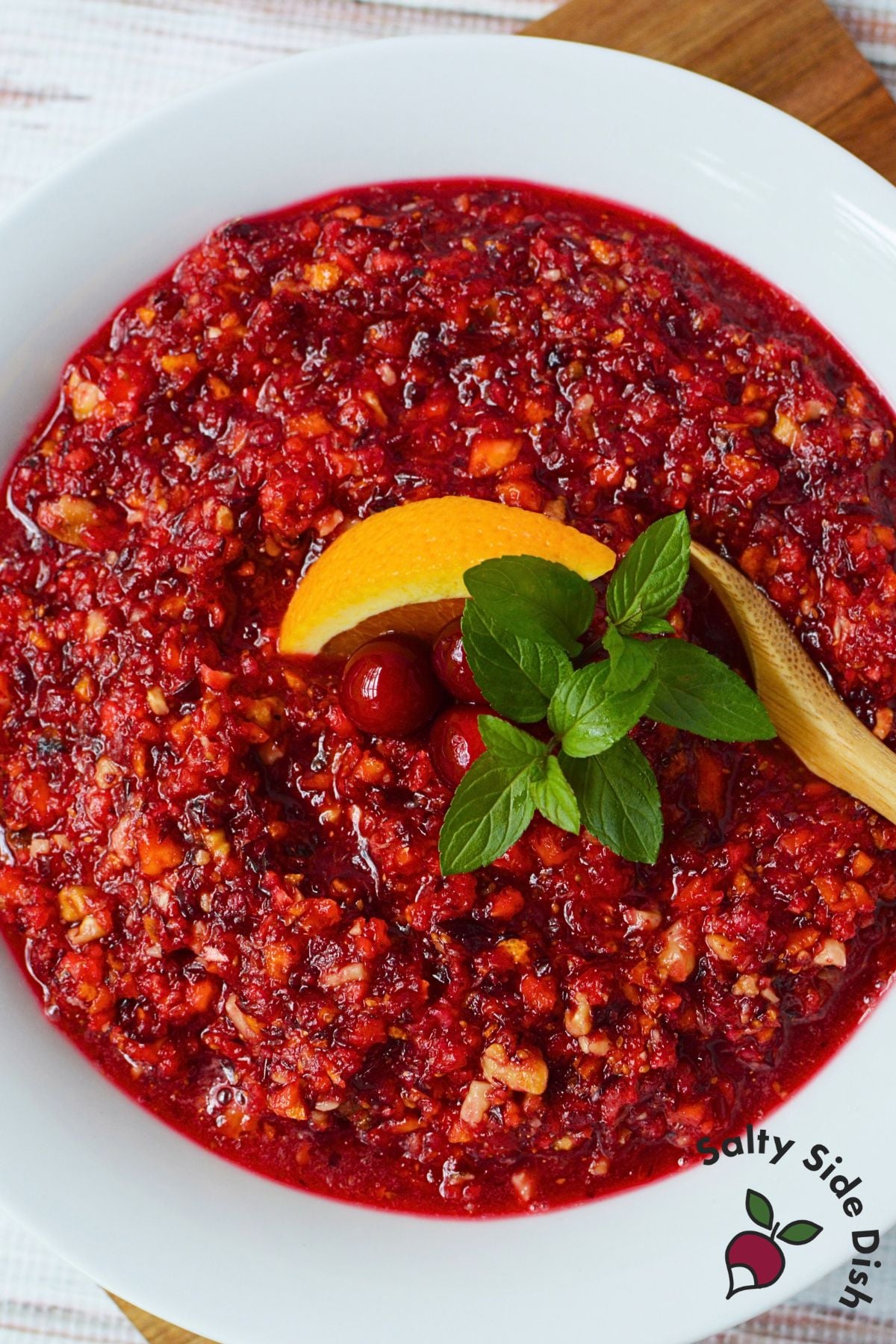 Homemade cranberry orange relish with walnuts served in a white bowl