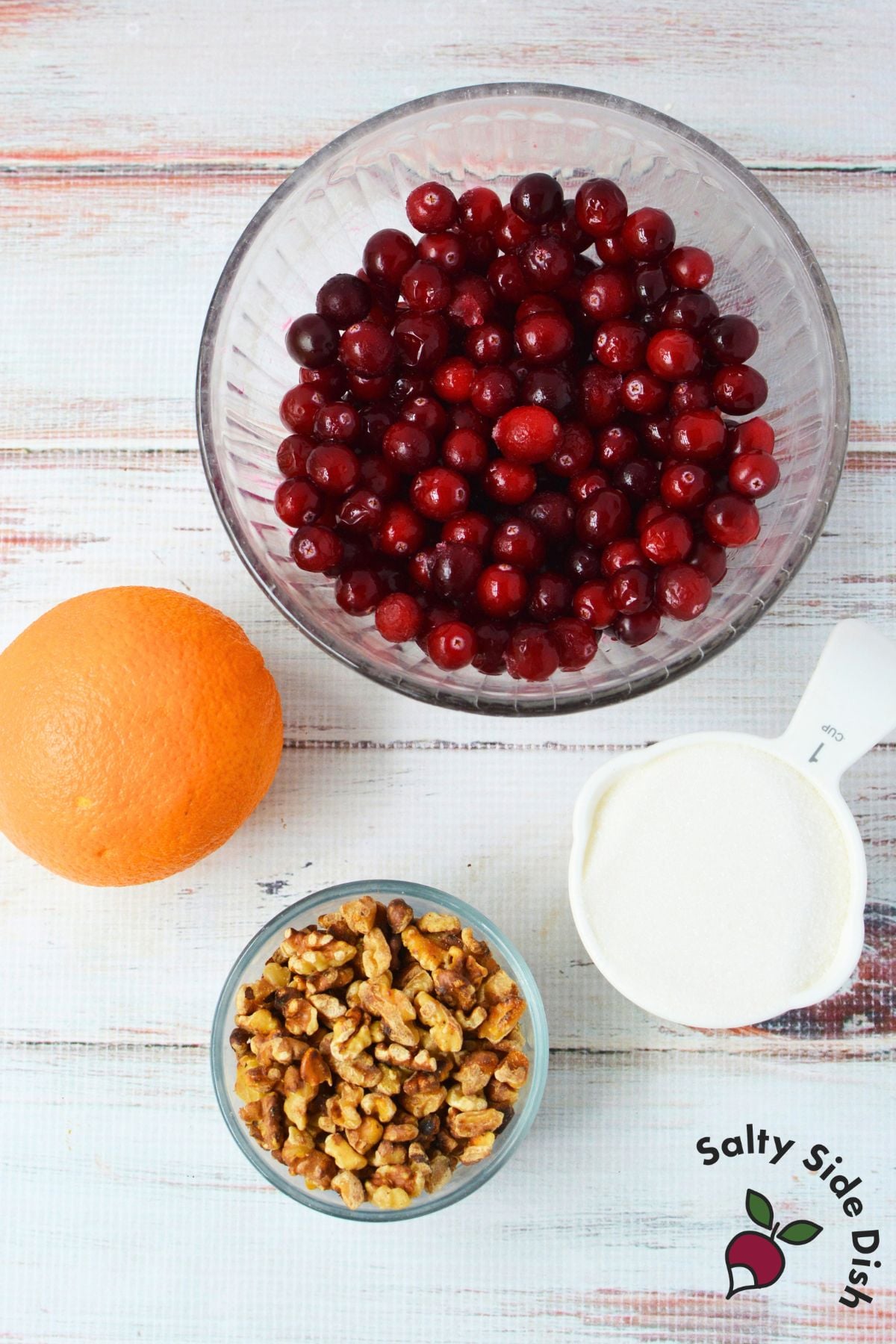 Cranberry orange relish ingredients including cranberries, orange, sugar, and walnuts