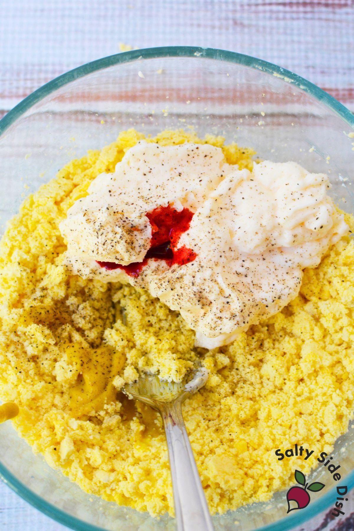 Mashed egg yolks mixed with mayonnaise, mustard, salt, pepper, and orange food coloring