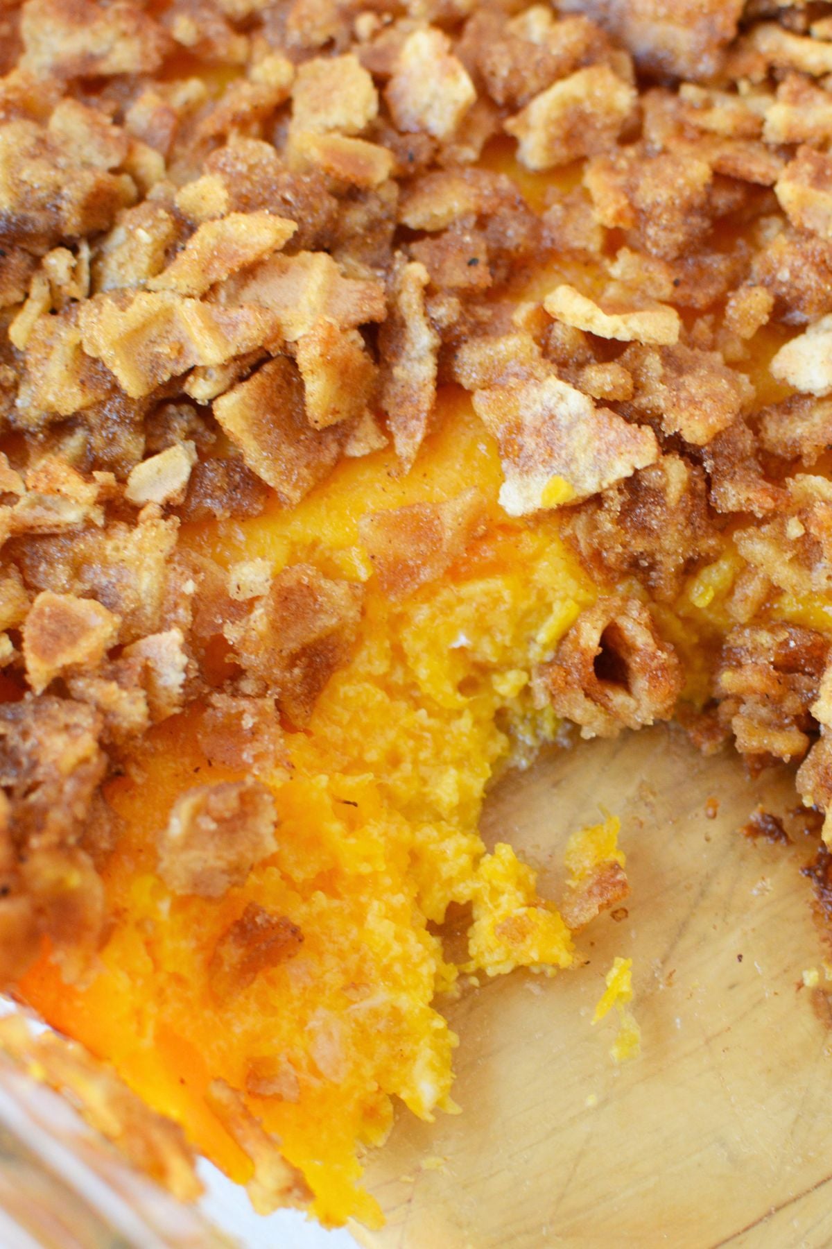 Inside view of butternut squash casserole with a soft orange filling and crunchy brown sugar waffle cone topping.